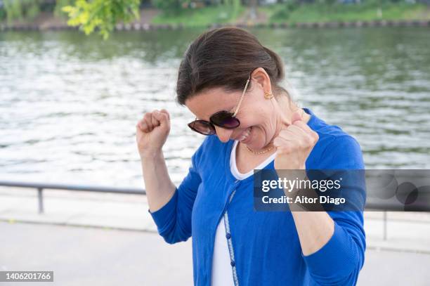 woman celebrates something . berlin, germany. - earnings season stock pictures, royalty-free photos & images