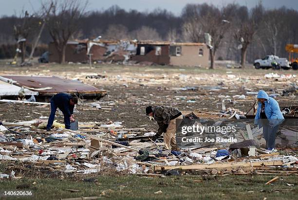 People look through the debris of homes that were destroyed when a tornado passed through the town on March 3, 2012 in Holton, Indiana. Severe...