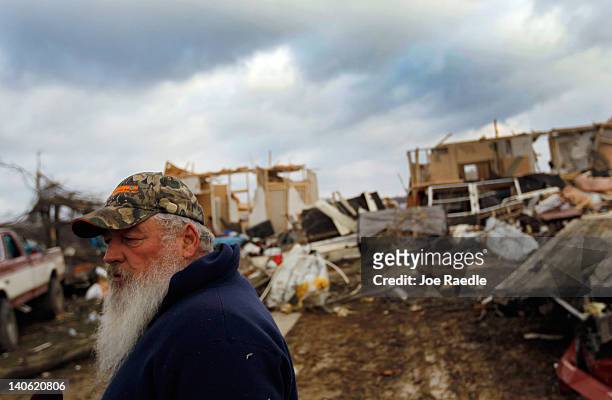 Dwane Patrick stands outside of what is left of his home after a tornado destroyed it on March 3, 2012 in Holton, Indiana. Severe weather and...