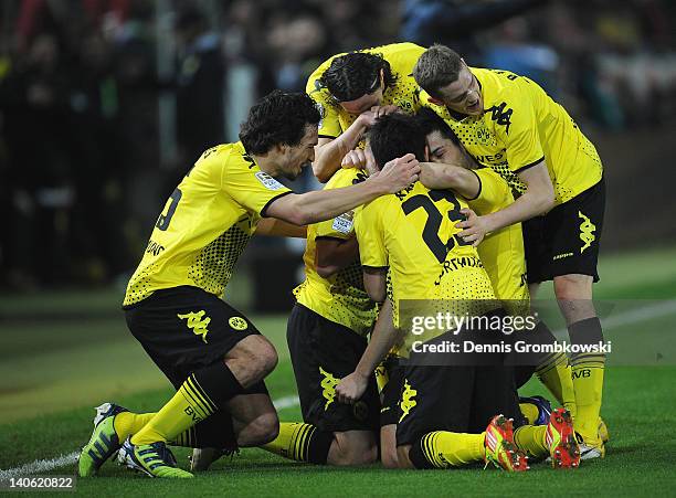Jakub Blaszczykowski of Dortmund celebrates with teammates after scoring his team's opening goal during the Bundesliga match between Borussia...