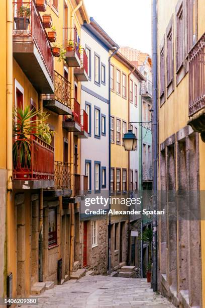 narrow multi colored street in porto old town, portugal - porto portugal stock pictures, royalty-free photos & images