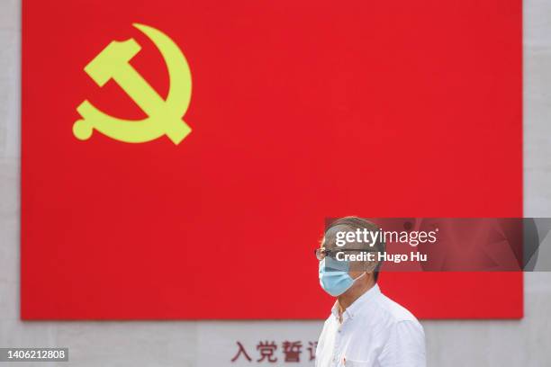 An old man with protective mask poses for photo under a CCP flag at the memorial hall of the first National Congress of CCP on July 01, 2022 in...