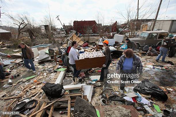 Friends and family help to recover items from the home of Melody Zollman after it was destroyed by a tornado March 3, 2012 in Henryville, Indiana....