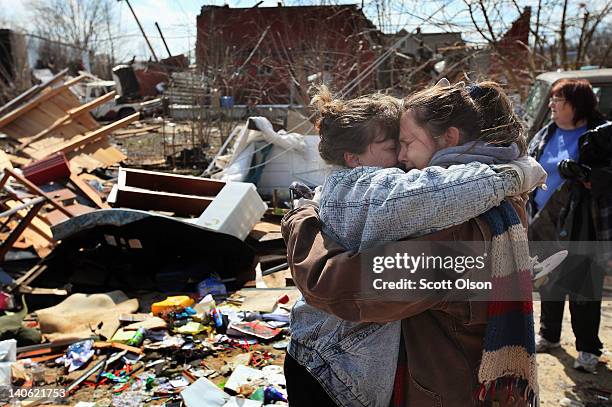 Melody Zollman gets a hug from her sister Michelle Browning as they stand in what was Zollman's home after it was destroyed by a tornado March 3,...