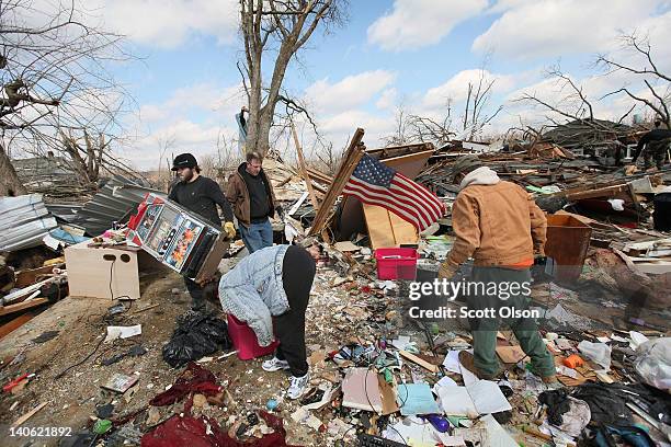 Friends and family help to recover items from the home of Melody Zollman after it was destroyed by a tornado March 3, 2012 in Henryville, Indiana....