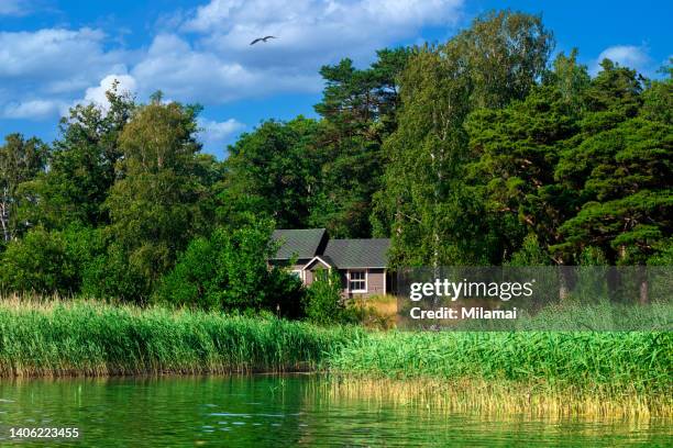 an idyllic old cabin and beach surrounded by beautiful green sea views, archipelago scenery. rymattyla, naantali, turku, finland. northern europe. - turku finland stock pictures, royalty-free photos & images