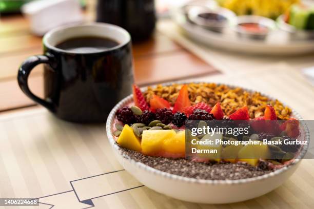 chia breakfast bowl with peaches, strawberries, granola, seeds, blackberries, coconut yogurt and coffee - fibre stock pictures, royalty-free photos & images