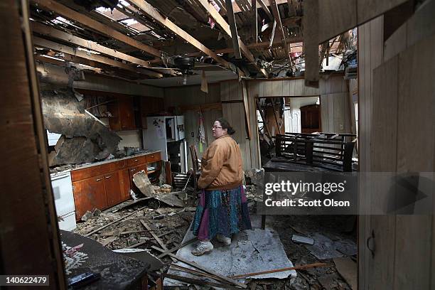 Leah Boylan looks at the damage to her sister's home after it was destroyed by yesterday's tornado March 3, 2012 in Henryville, Indiana. Dozens of...