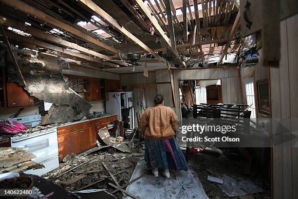 Leah Boylan looks at the damage to her sister's home after it was destroyed by yesterday's tornado March 3, 2012 in Henryville, Indiana. Dozens of...