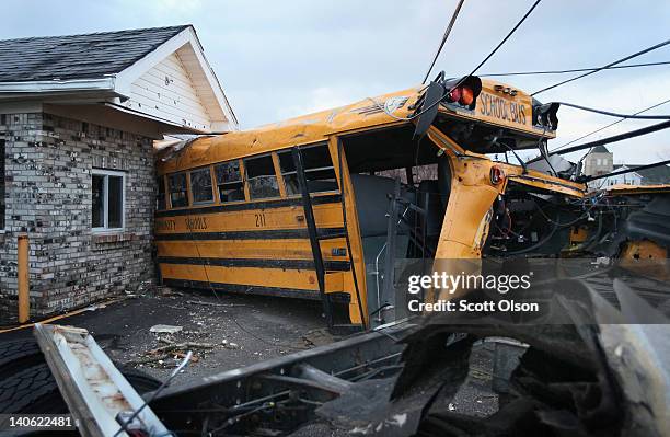 School bus is lodged in a home where it came to rest after being tossed by yesterday's tornado March 3, 2012 in Henryville, Indiana. Dozens of people...