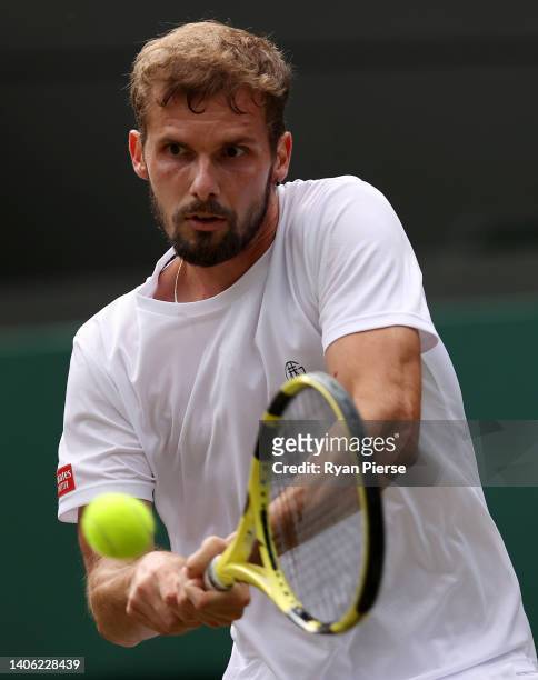 Oscar Otte of Germany plays a backhand against Carlos Alcaraz of Spain during their Men's Singles Third Round match on day five of The Championships...