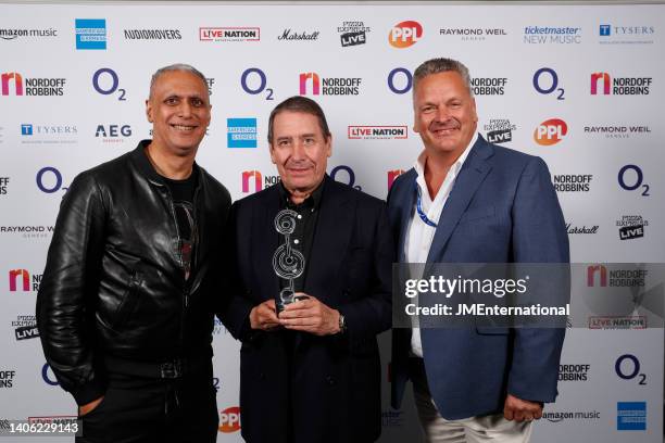 Nitin Sawnhey, Jools Holland and his sponsor from Tysers in the Winners Room at the Nordoff Robbins O2 Silver Clef Awards at The Grosvenor House...