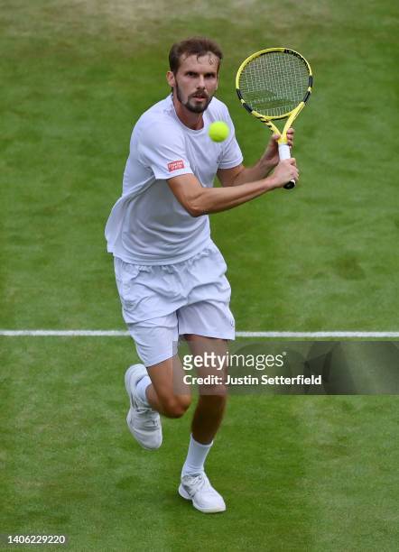 Oscar Otte of Germany plays a backhand against Carlos Alcaraz of Spain during their Men's Singles Third Round match on day five of The Championships...