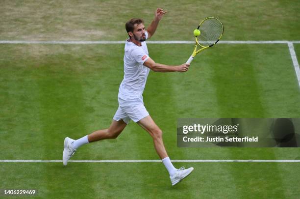 Oscar Otte of Germany plays a backhand against Carlos Alcaraz of Spain during their Men's Singles Third Round match on day five of The Championships...