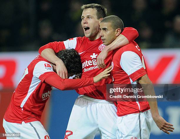 Mohamed Zidan of Mainz celebrates with teammates Radoslav Zabavnik and Nicolai Mueller after scoring his team's first goal during the Bundesliga...