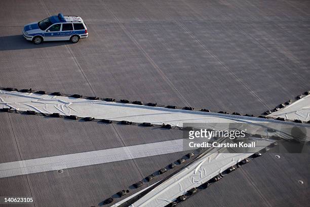 Police car is parked on the tarmac of the airport during an emergency drill at new Berlin Brandenburg Airport on March 3, 2012 in Berlin, Germany. At...