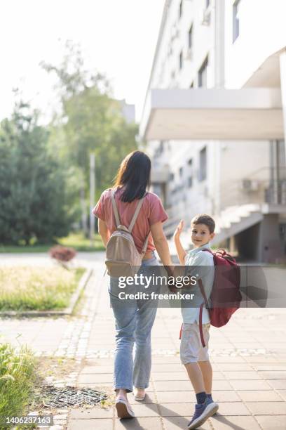 walking her son to school - first day of summer stock pictures, royalty-free photos & images