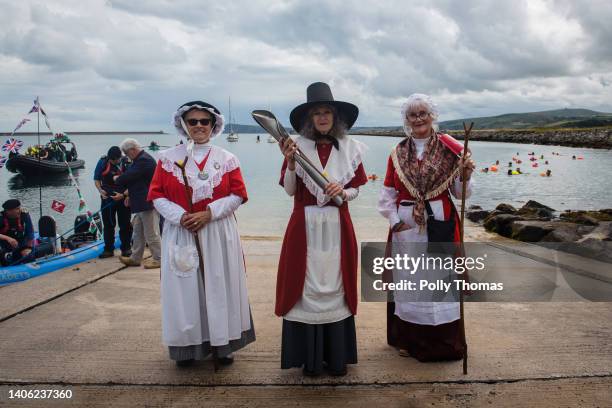 Baton bearers in traditional Welsh costume hold the Queen's Baton during the Birmingham 2022 Queen's Baton Relay at a visit to Goodwick on July 1,...