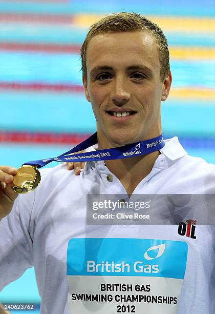 Robert Renwick of the City of Glasgow celebrates with the gold medal after winning the Men's Open 400m Freestyle Final during day one of the British...