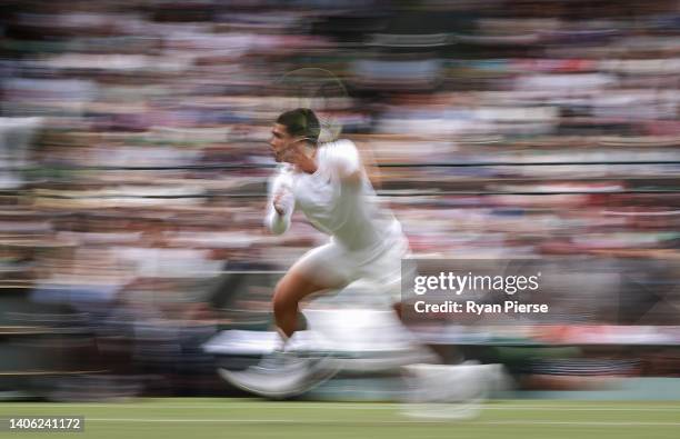 Carlos Alcaraz of Spain plays a backhand against Oscar Otte of Germany during their Men's Singles Third Round match on day five of The Championships...