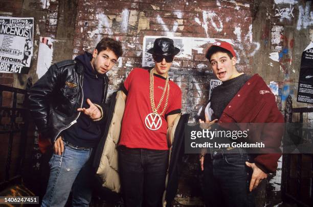 Portrait of members of American Rap group Beastie Boys as they pose in front of a mural , 1987. Pictured are, from left, Mike D , MCA , and Ad-Rock .