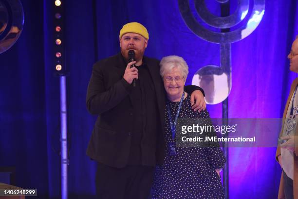 Sadie presents the Best Male Award to Tom Walker on stage during the Nordoff Robbins O2 Silver Clef Awards at The Grosvenor House Hotel on July 01,...