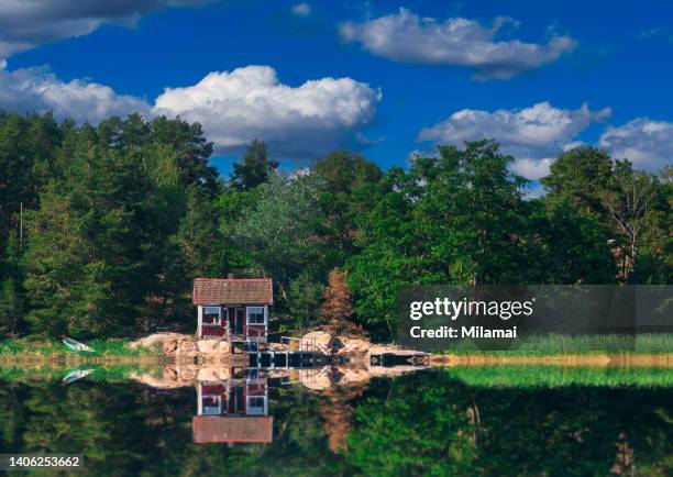 a red sauna cabin, wooden dock and beach surrounded by beautiful sea views, archipelago scenery. rymattyla, naantali, turku, finland. northern europe. - finnish culture stock-fotos und bilder