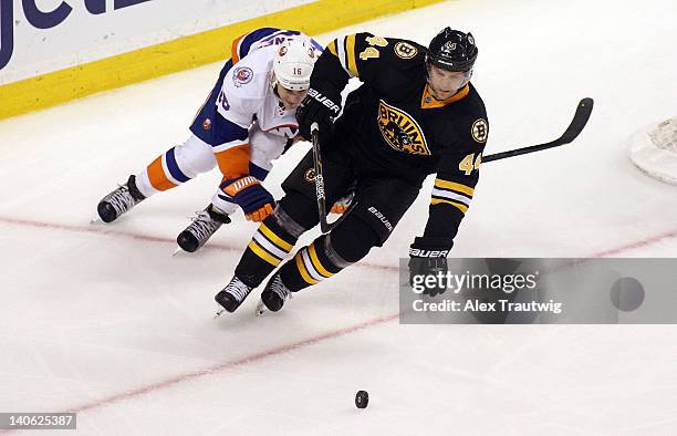 Dennis Seidenberg of the Boston Bruins skates with the puck against Marty Reasoner of the New York Islanders at TD Garden on March 3, 2012 in Boston,...