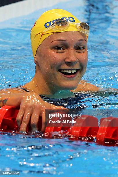 Sarah Sjoestroem of Sweden smiles after the Women's 100m Butterfly Guest Final during day one of the British Gas Swimming Championships at the London...