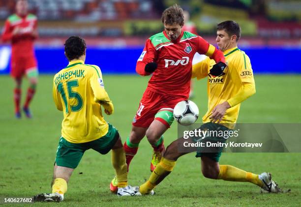 Dmitri Sychev of FC Lokomotiv Moscow battles for the ball with Maksim Zhavnerchik and Igor Armas of FC Kuban Krasnodar during the Russian Football...