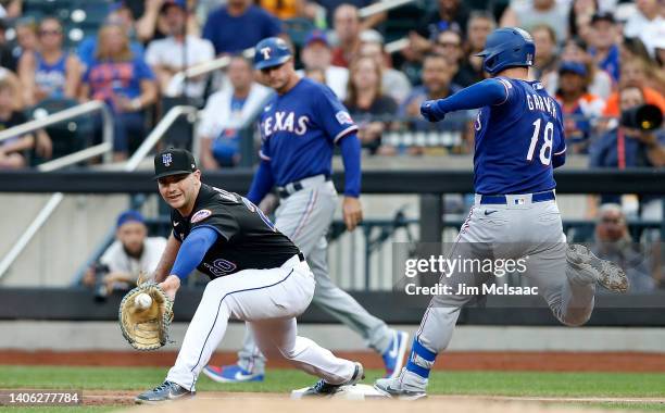 Mitch Garver of the Texas Rangers beats the throw to Pete Alonso of the New York Mets for a second inning infield single at Citi Field on July 01,...