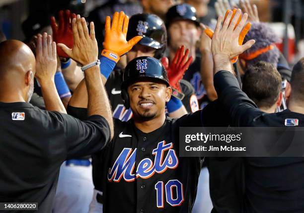 Eduardo Escobar of the New York Mets celebrates after his three run home run during the fourth inning against the Texas Rangers with his teammates in...
