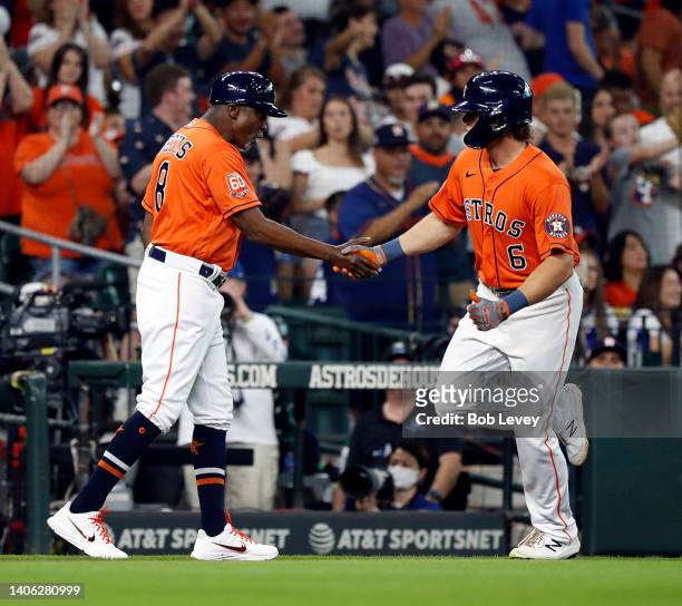 Jake Meyers of the Houston Astros receives congratulations from Gary Pettis after hitting a solo home run in the second inning against the Los...
