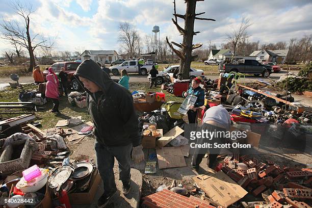 Volunteers salvage valuables after a tornado destroyed a home March 3, 2012 in Marysville, Indiana. Dozens of people were killed as severe weather...