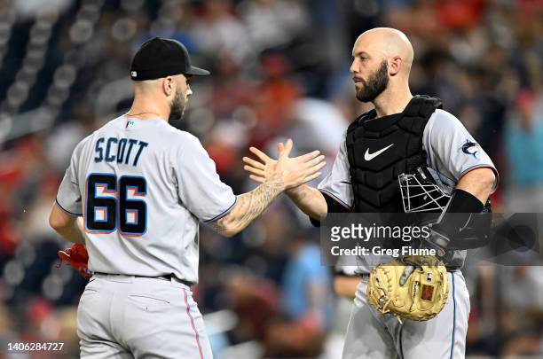 Tanner Scott of the Miami Marlins celebrates with Jacob Stallings after a 6-3 victory against the Washington Nationals at Nationals Park on July 01,...
