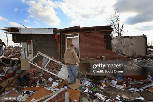 Jim Mappins enters a home that belonged to his mother after it was destroyed by a tornado March 3, 2012 in Marysville, Indiana. Dozens of people were...