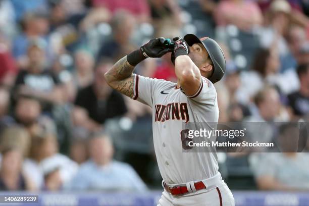 David Peralta of the Arizona Diamondbacks gestures as he circles the bases after hyitting a solo home run against the Colorado Rockies in the sixth...