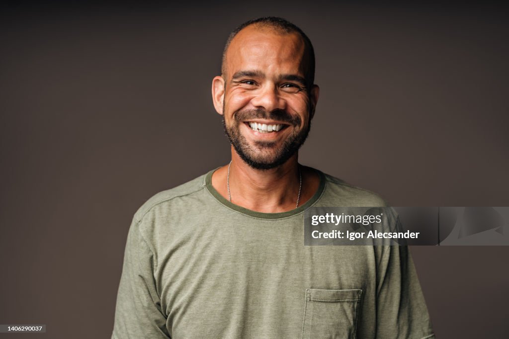 Happy and relaxed middle aged man in studio