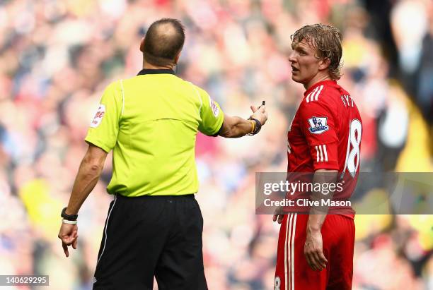 Dirk Kuyt of Liverpool argues with the referee Mark Halsey during the Barclays Premier League match between Liverpool and Arsenal at Anfield on March...