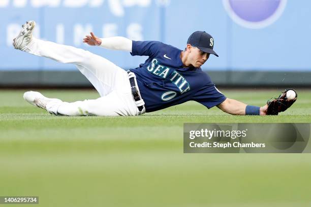 Sam Haggerty of the Seattle Mariners makes a diving catch on a ball hit by Nick Allen of the Oakland Athletics during the fifth inning at T-Mobile...