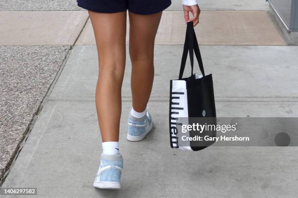 Shopper carries a bag from Lululemon at the Toronto Premium Outlets shopping mall on July 1 in Halton Hills, Ontario.