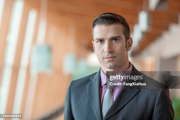 portrait of hispanic mid adult businessman in office lobby - government accountability office stock pictures, royalty-free photos & images