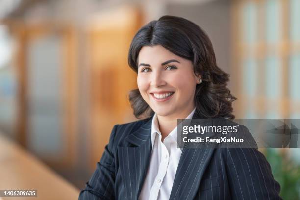 portrait of young caucasian businesswoman female university student smiling at camera in suit - politicians female stock pictures, royalty-free photos & images