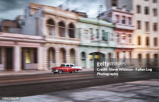 restored american classic car in havana drives past historic buildings along the famous malecon  seawall - old havana bildbanksfoton och bilder