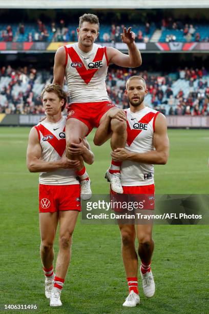 Luke Parker of the Swans is chair from the ground after playing his 250th game, the round 16 AFL match between the Essendon Bombers and the Sydney...