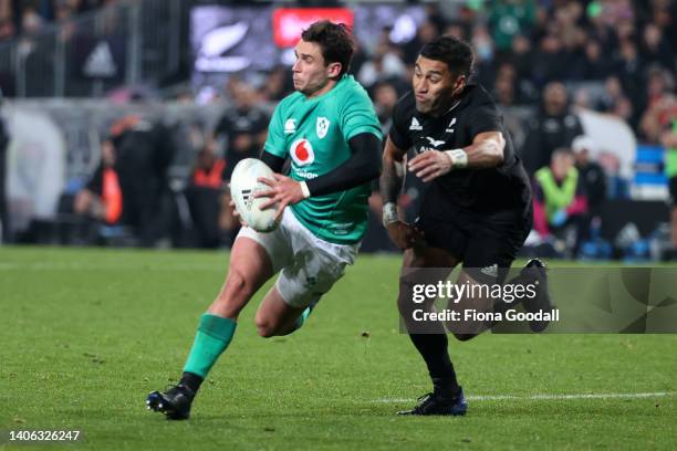 Joey Carbery of Ireland is tackled by Rieko Ioane of the All Blacks during the International test Match in the series between the New Zealand All...