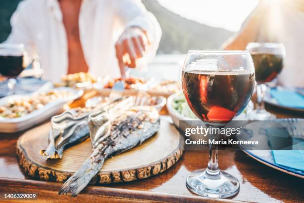 group of friends eating together on sailboat. - dinner boat imagens e fotografias de stock