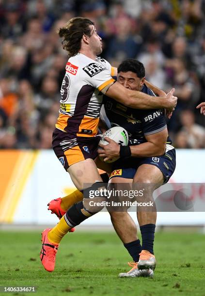 Jason Taumalolo of the Cowboys is tackled by Patrick Carrigan of the Broncos during the round 16 NRL match between the North Queensland Cowboys and...