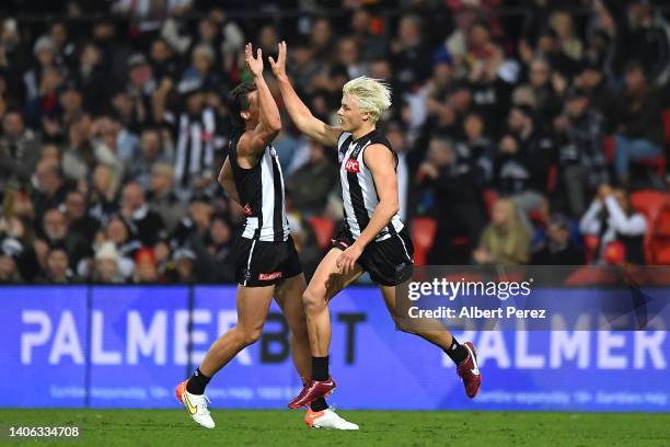 Jack Ginnivan of the Magpies celebrates kicking a goal during the round 16 AFL match between the Gold Coast Suns and the Collingwood Magpies at...