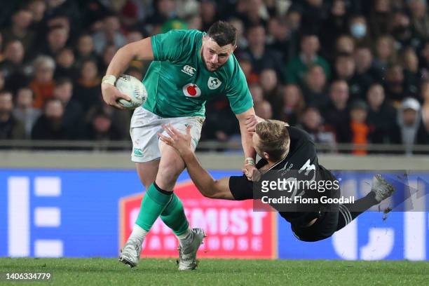 Robbie Henshaw of Ireland fends Braydon Ennor of the All Blacks during the International test Match in the series between the New Zealand All Blacks...
